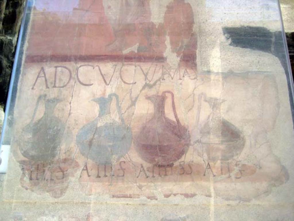 VI.14, Herculaneum, June 2011.
Detail from the painted pilaster on the left of the entrance doorway showing the painted pitchers.
Photo courtesy of Sera Baker.